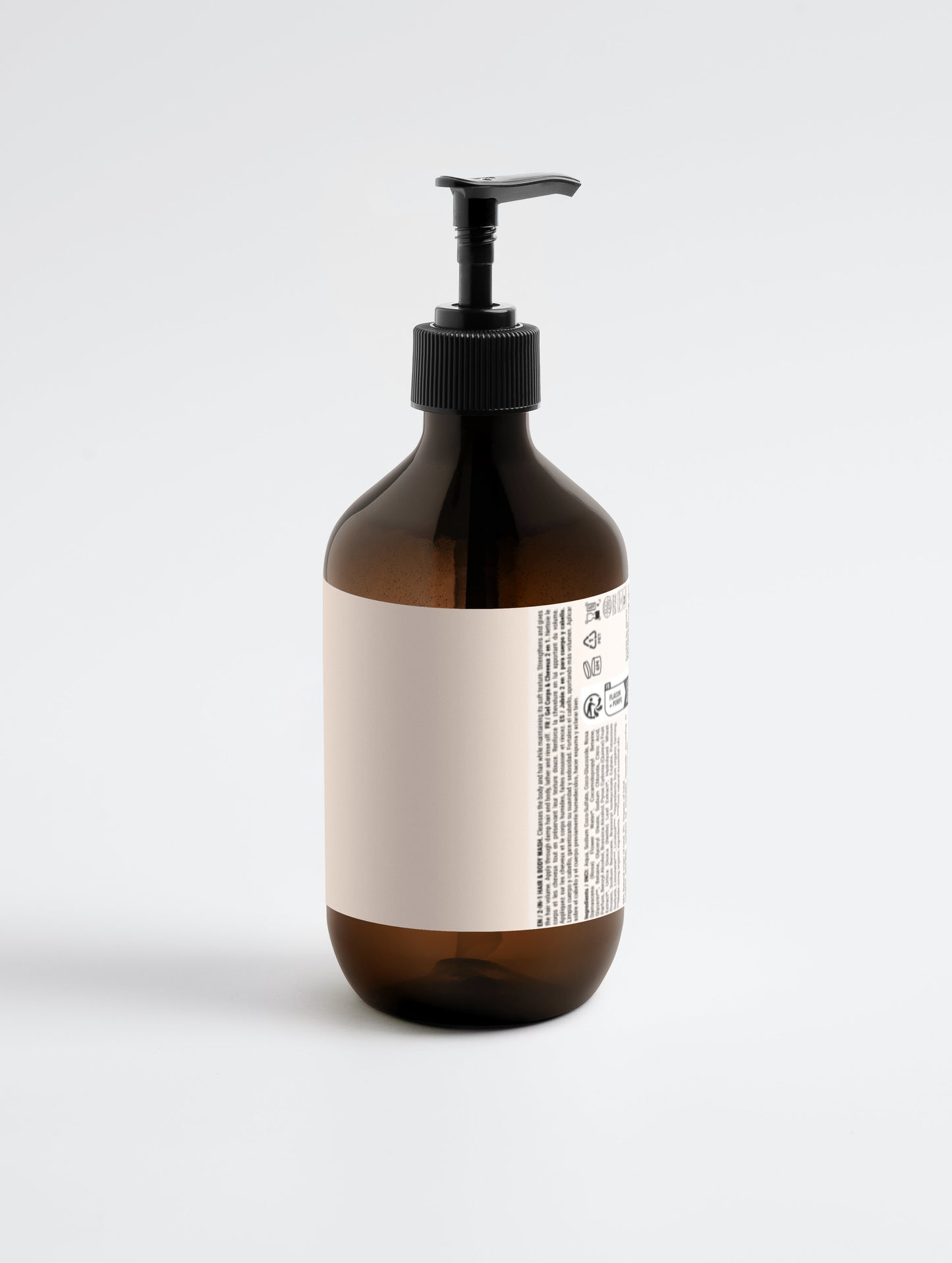 Brown bottle with black pump and white label on a light gray background