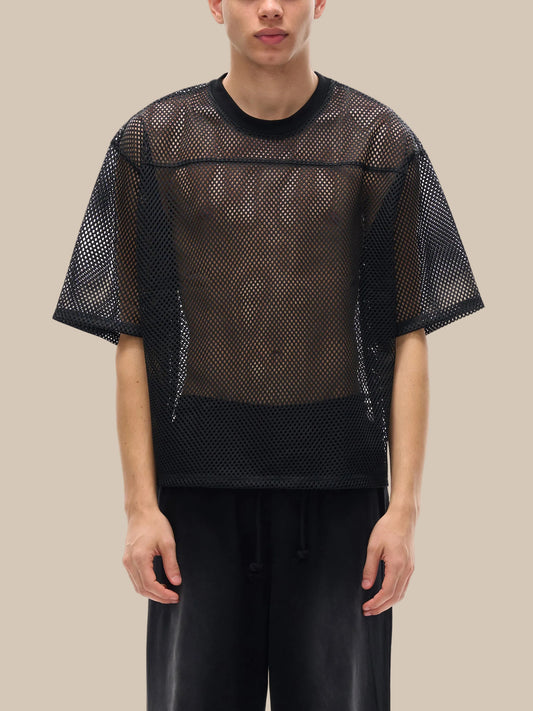 Model wearing the sustainable Future-Homme activewear boxy mesh tee in black frontside on a white background.