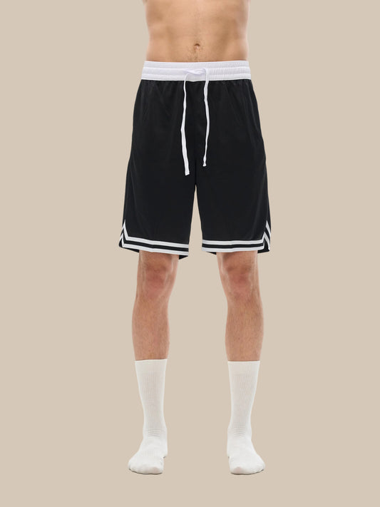 Lower half of model wearing the sustainable Future-Homme activewear classic stripe trim basketball short in black front side view on a white background