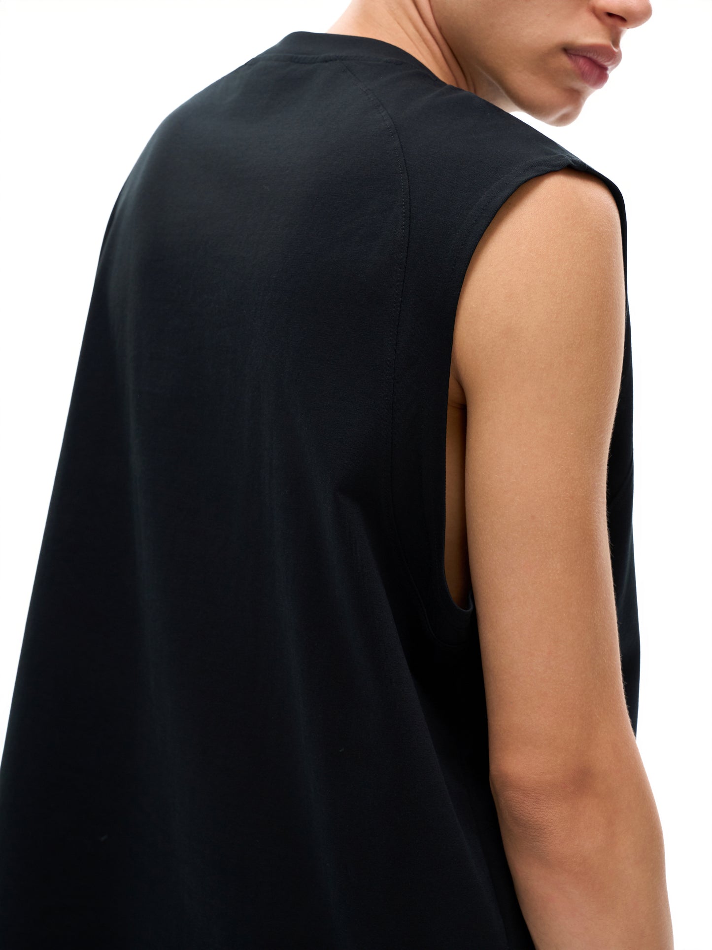 Model wearing the sustainable Future-Homme activewear quick dry performance tank in 240 GSM in black backside view on a white background