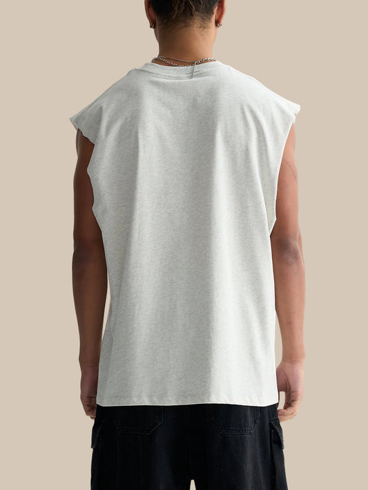 Person wearing a sleeveless gray shirt on a white background