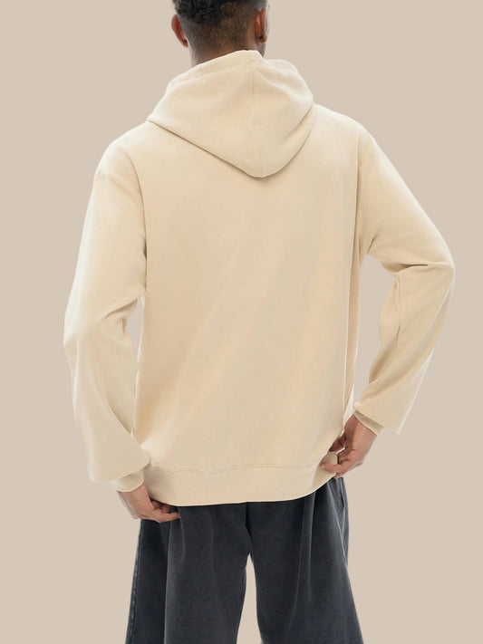 Person wearing a beige hoodie from behind on a white background