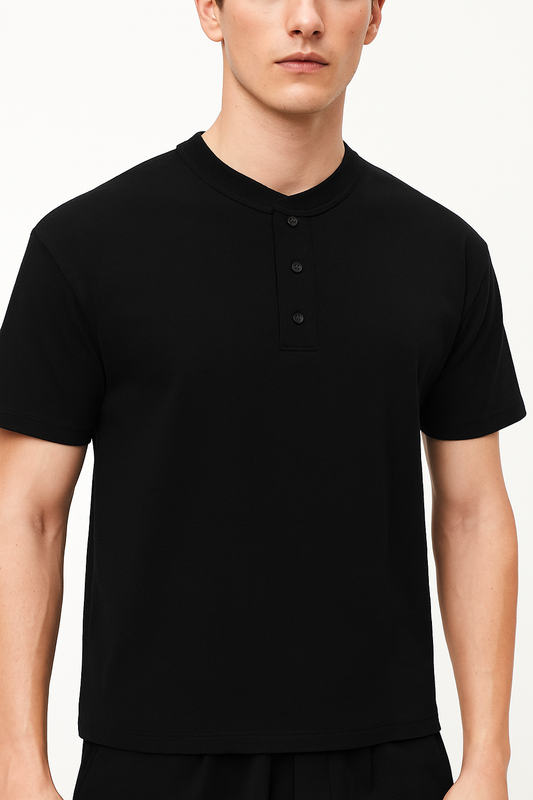 Model wearing the sustainable Future-Homme daily uniform three button short sleeve henley 280 GSM in black frontside on a white background