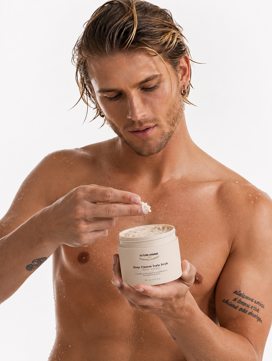 Man applying cream from a jar on a white background
