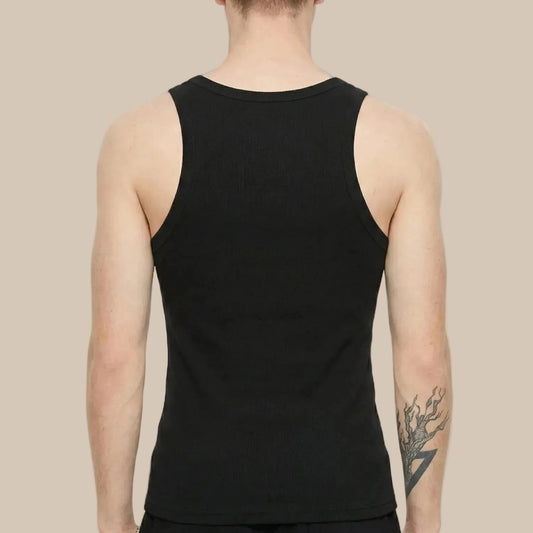 Person wearing a black tank top on a sand background