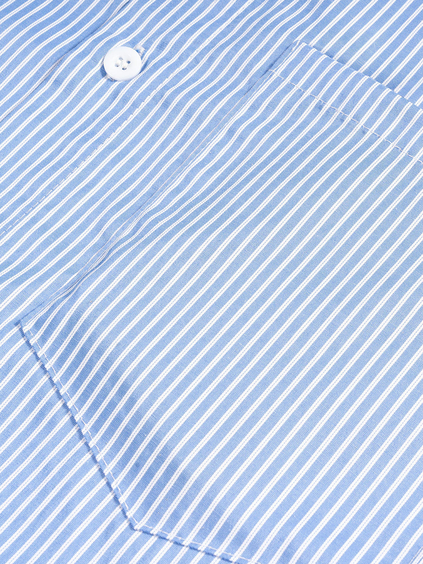 Close-up of a blue and white striped fabric with a button.