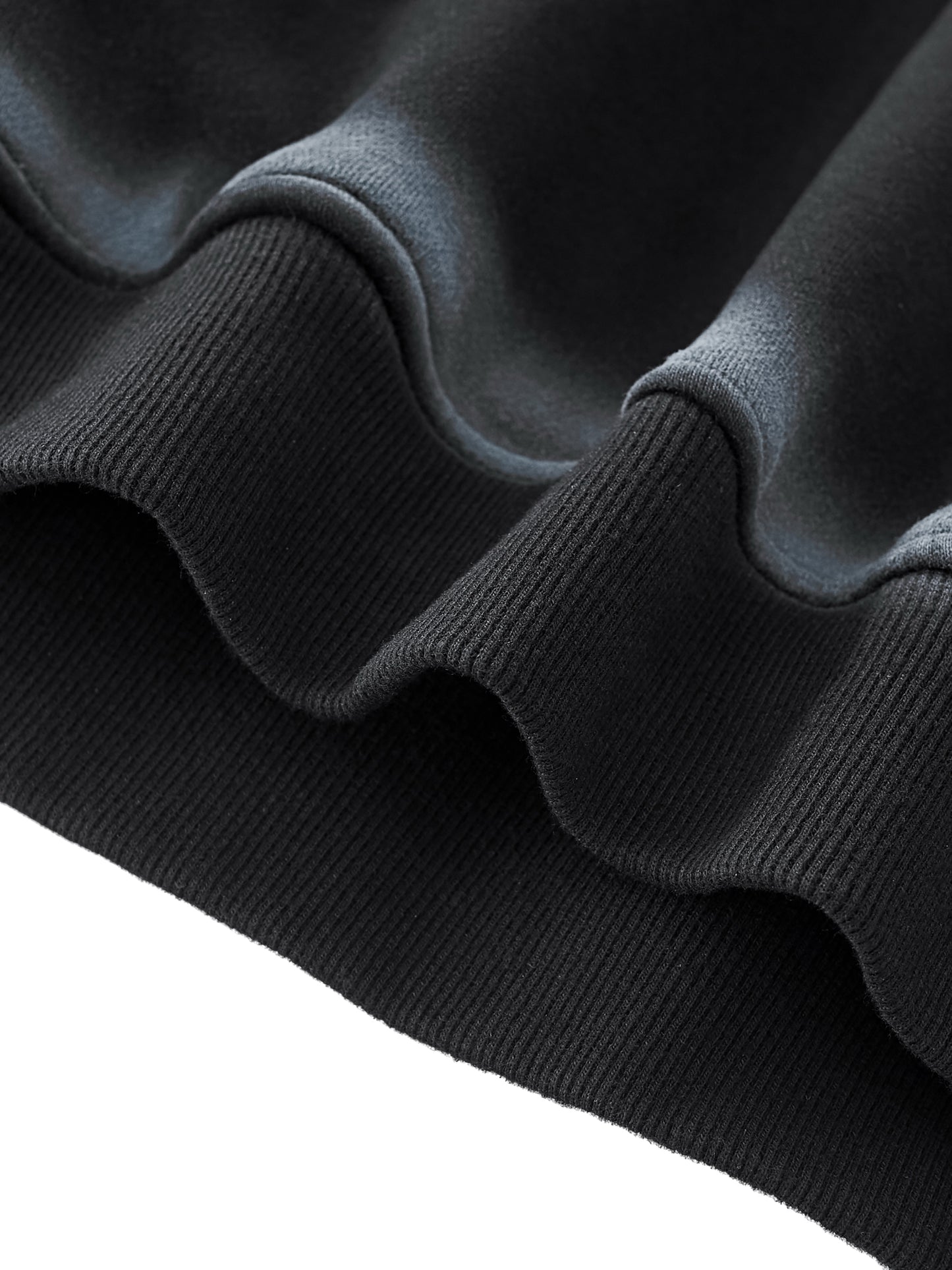 Up close flat lay of the Future-Homme Fleece Please Hoodie waist band in black with white chalk trim on a white background