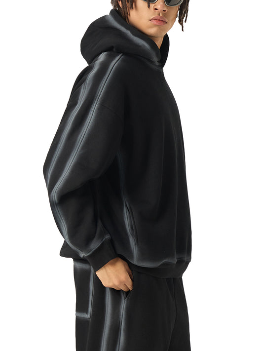 Model wearing the Future-Homme Fleece Please Hoodie in black with white chalk trim side view on a white background