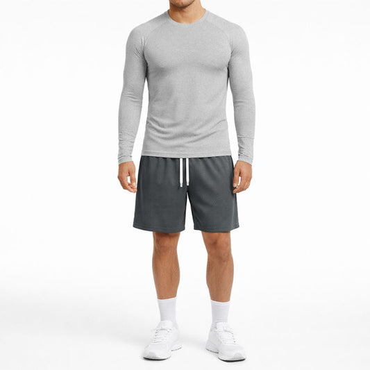 Person wearing a gray long-sleeve shirt and gray shorts on a white background