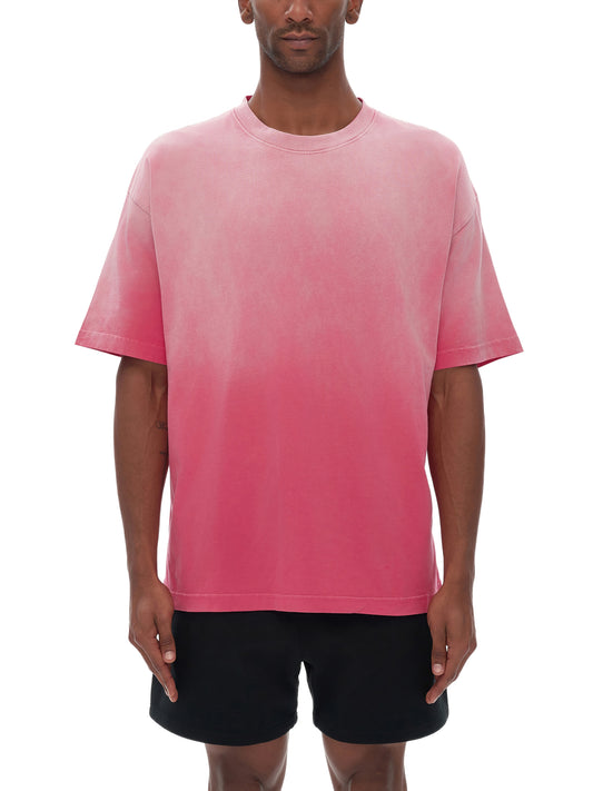A Future-Homme model wearing the Ombre Effect short sleeve t-shirt in pink with black shorts on a white background
