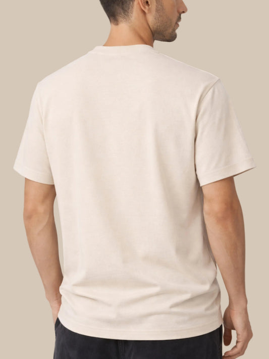 Man wearing a beige t-shirt on a white background