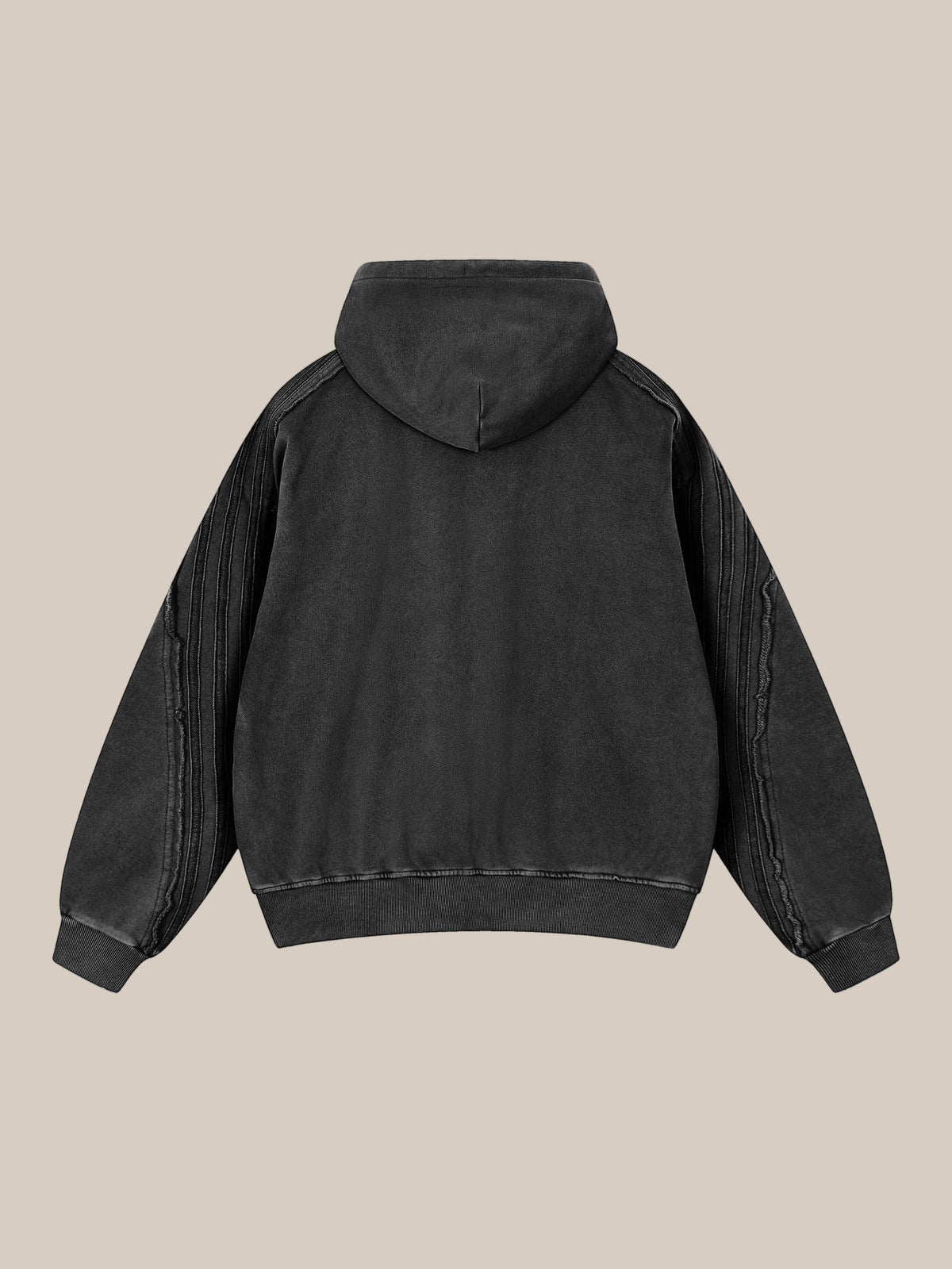Back flat lay of a black hoodie on a beige background.