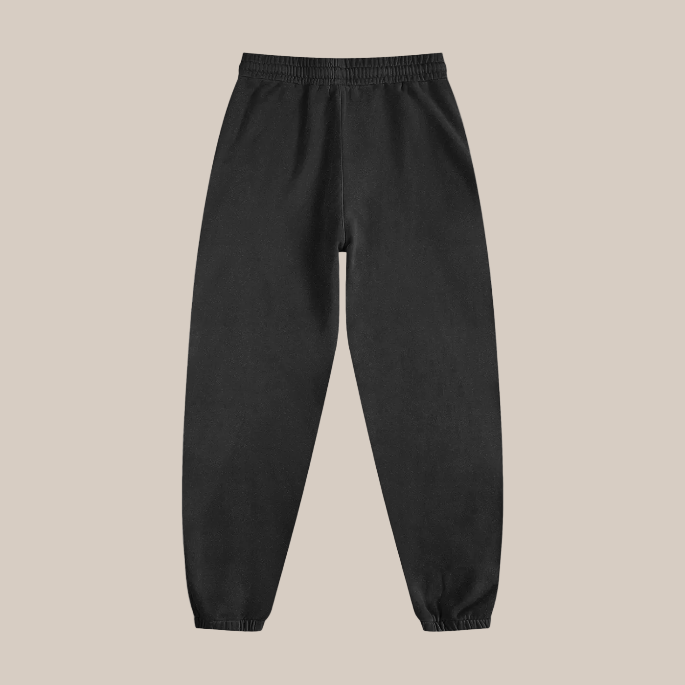 Black sweatpants on a beige background