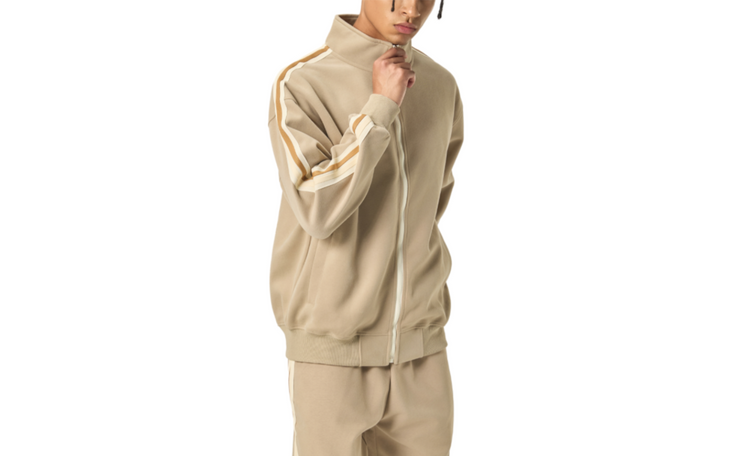 A model wearing the beige Future-Homme Track suit on a white background