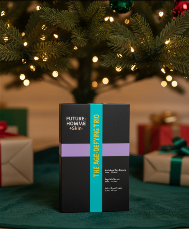 The Age-Defying Trio gift set box from the Future-Homme Plus Skin line displayed underneath a Christmas tree as a gift. 