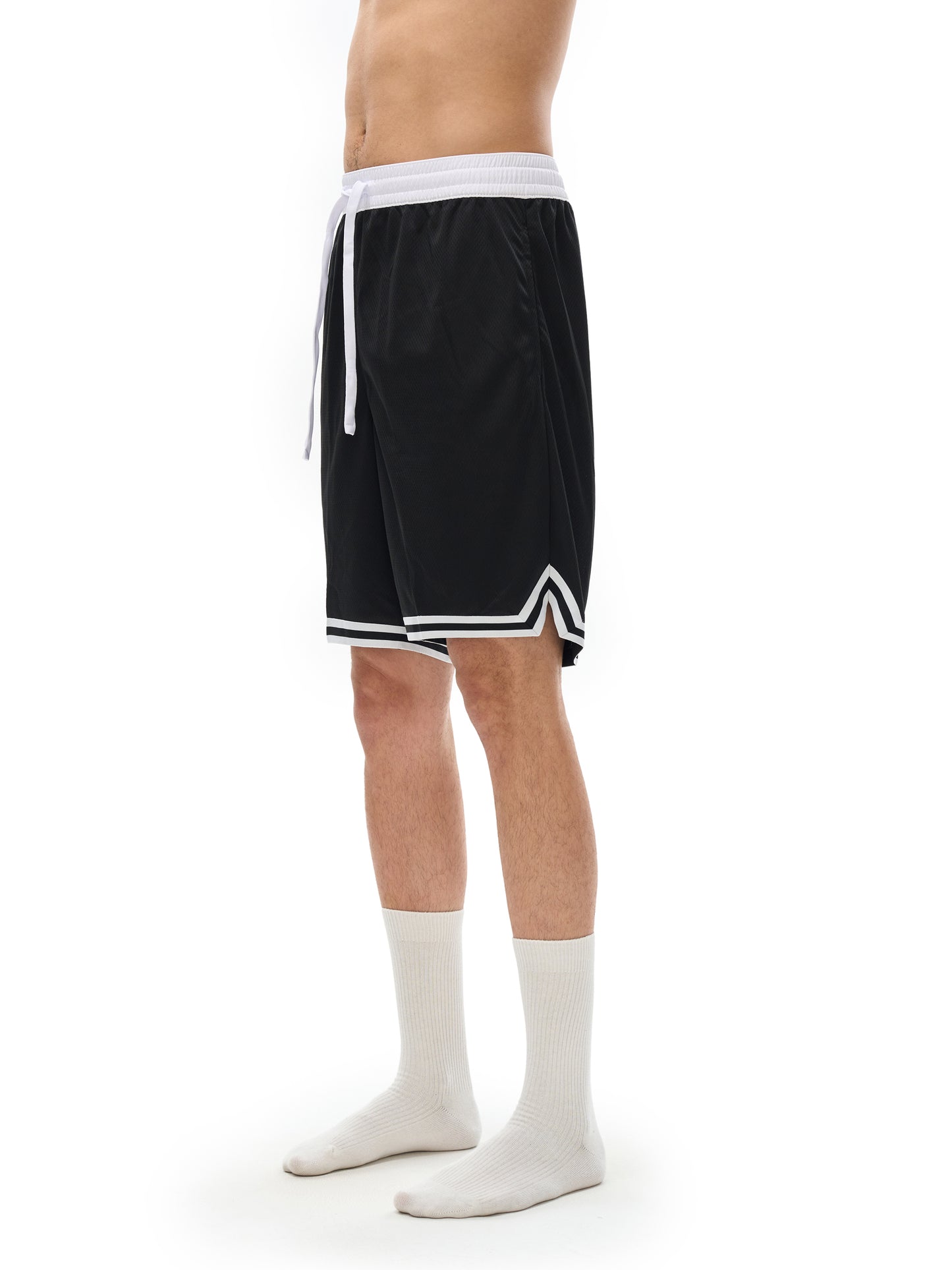 Lower half of model wearing the sustainable Future-Homme activewear classic stripe trim basketball short in black front right side view on a white background