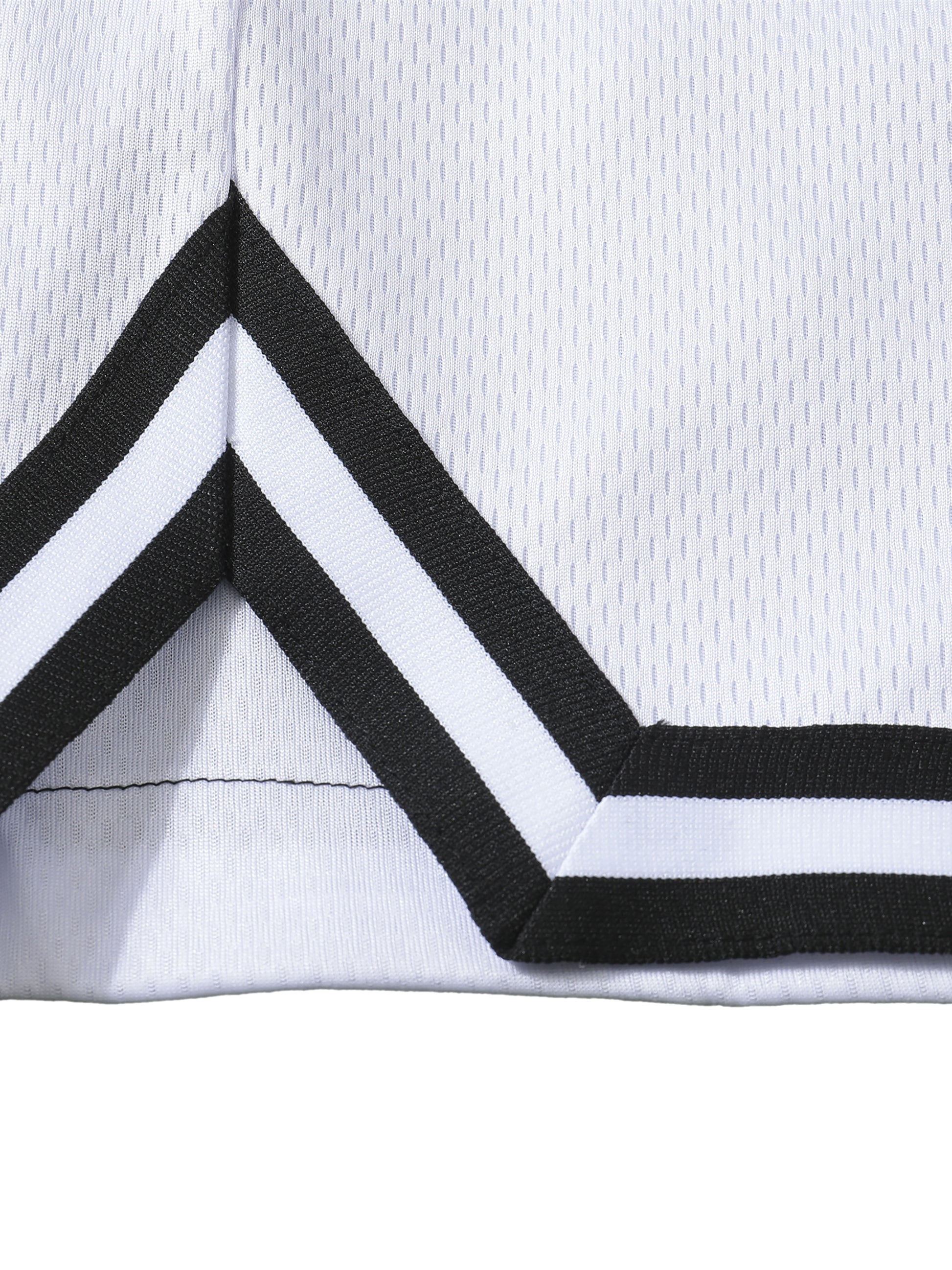 Detail stripe trim of the sustainable Future-Homme activewear classic stripe trim basketball short in white side on a white background