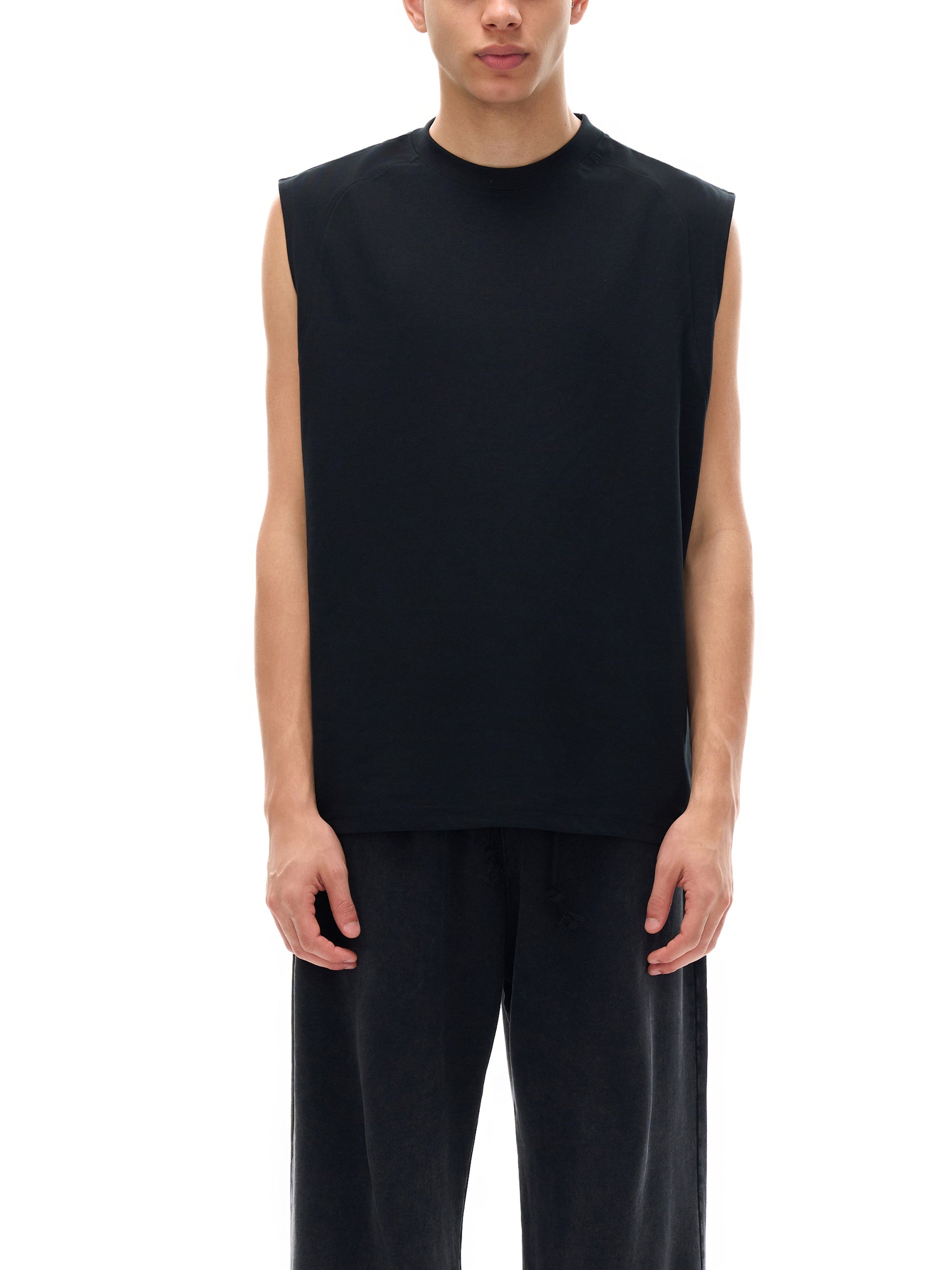 Model wearing the sustainable Future-Homme activewear quick dry performance tank in 240 GSM in black  frontside on a white background