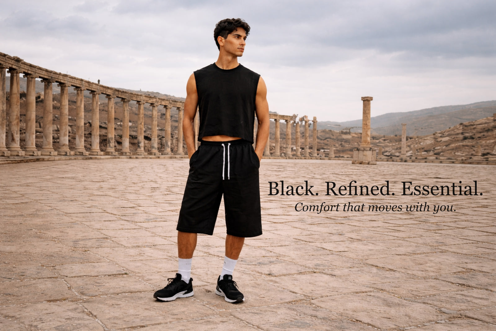 Man wearing 'Future-Homme' black sleeveless shirt and shorts standing on a stone platform with text overlay.