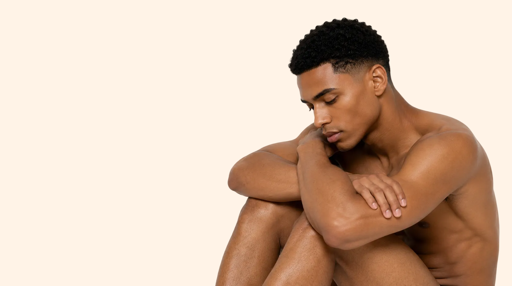 Man sitting with his arms crossed on a white background