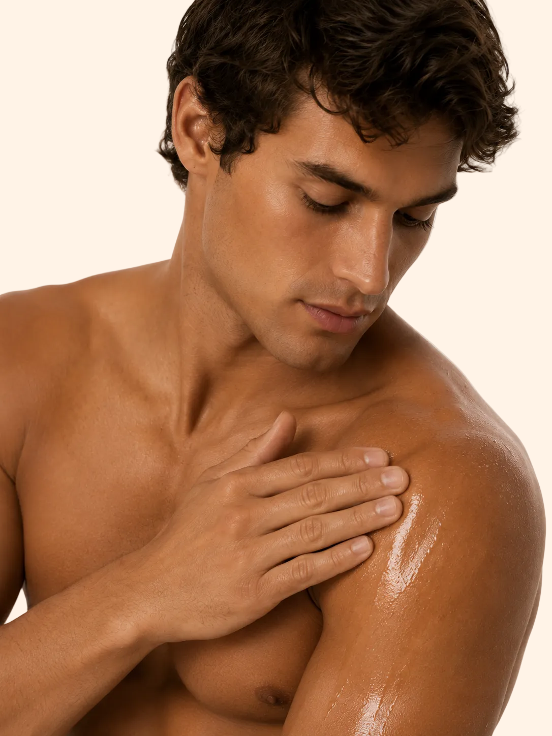 Man applying sunscreen to his shoulder on a plain background