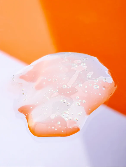 Close-up of a white substance with bubbles on an orange background