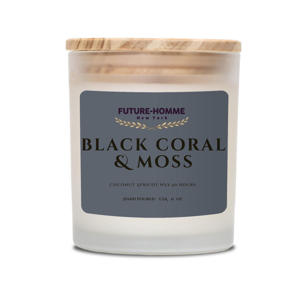 Candle with 'Black Coral & Moss' label and wooden lid on a white background