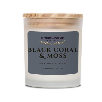 Candle with 'Black Coral & Moss' label and wooden lid on a white background