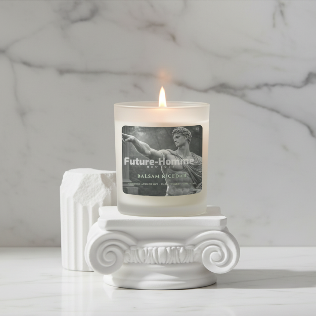 Candle with a label on a decorative white pedestal against a marble background