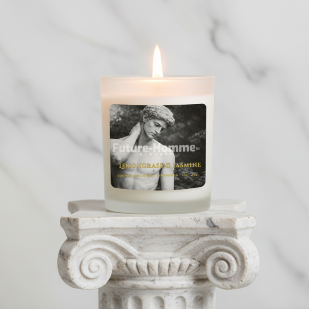 Candle with a label on a decorative stone pedestal against a marble background