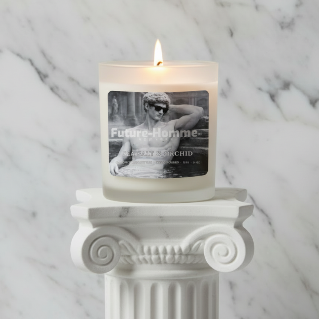Candle labeled 'Future Homme' on a decorative white column against a marble background