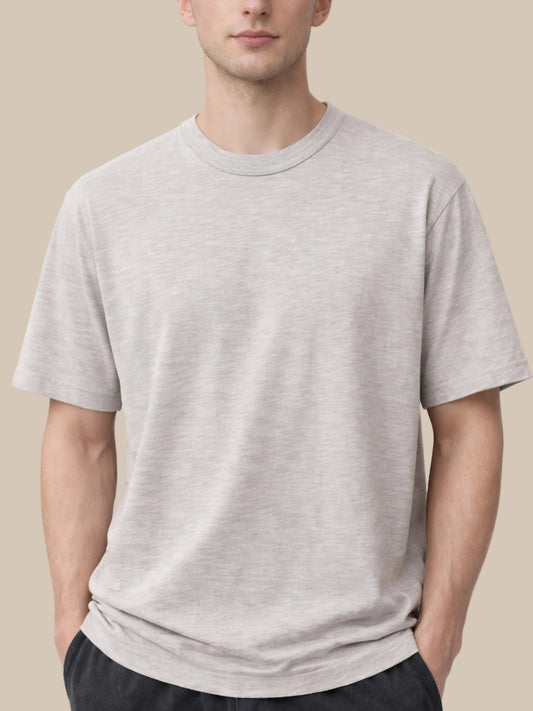 Man wearing a plain gray t-shirt on a white background