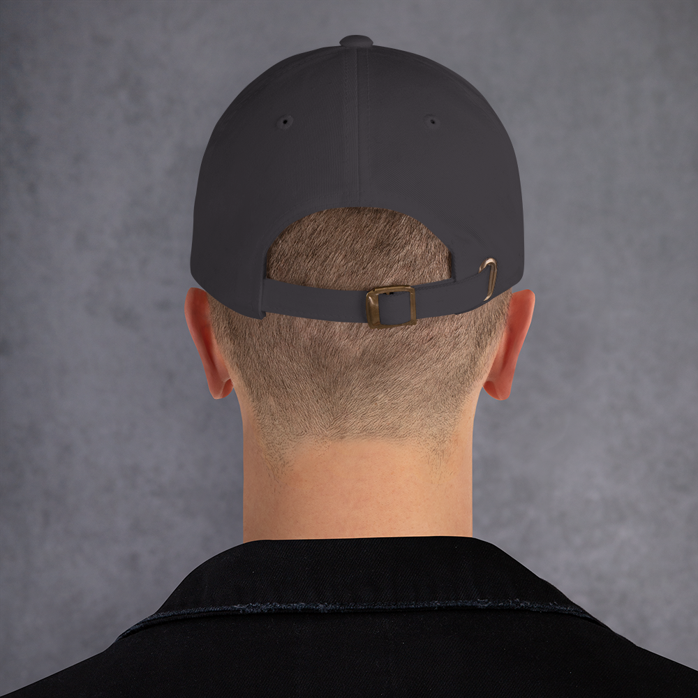 Backside of a model wearing a dark gray cap with a brown buckle on a gray background