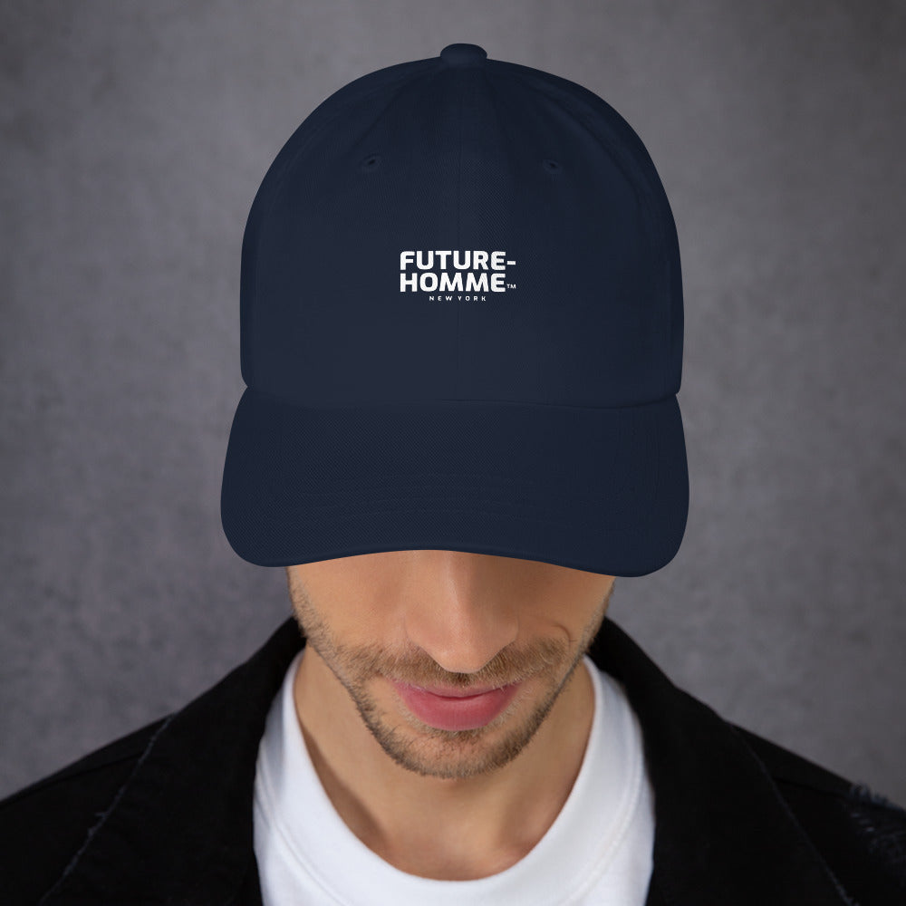 Male model wearing a navy baseball cap with Future-Homme logo in white letters on a gray background 