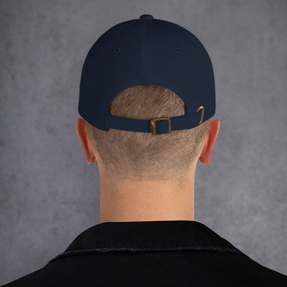 Backside of a male model wearing a navy Future-Homme baseball cap on a gray background. 