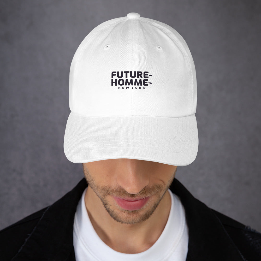 Male model wearing a white baseball cap with the Future-Homme logo on a grey background. 