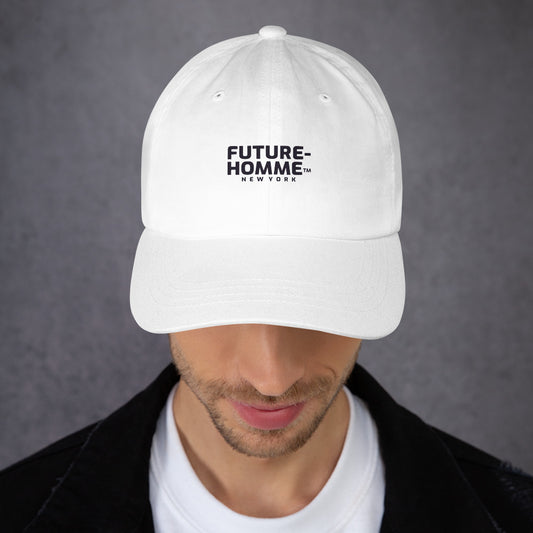 Male model wearing a white baseball cap with the Future-Homme logo on a grey background. 