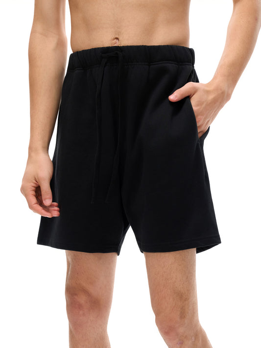 Lower half of male model wearing the sustainable made-to order 425 GSM Future-Homme daily uniform heavyweight structured loose cotton shorts in black frontside on a white background. 