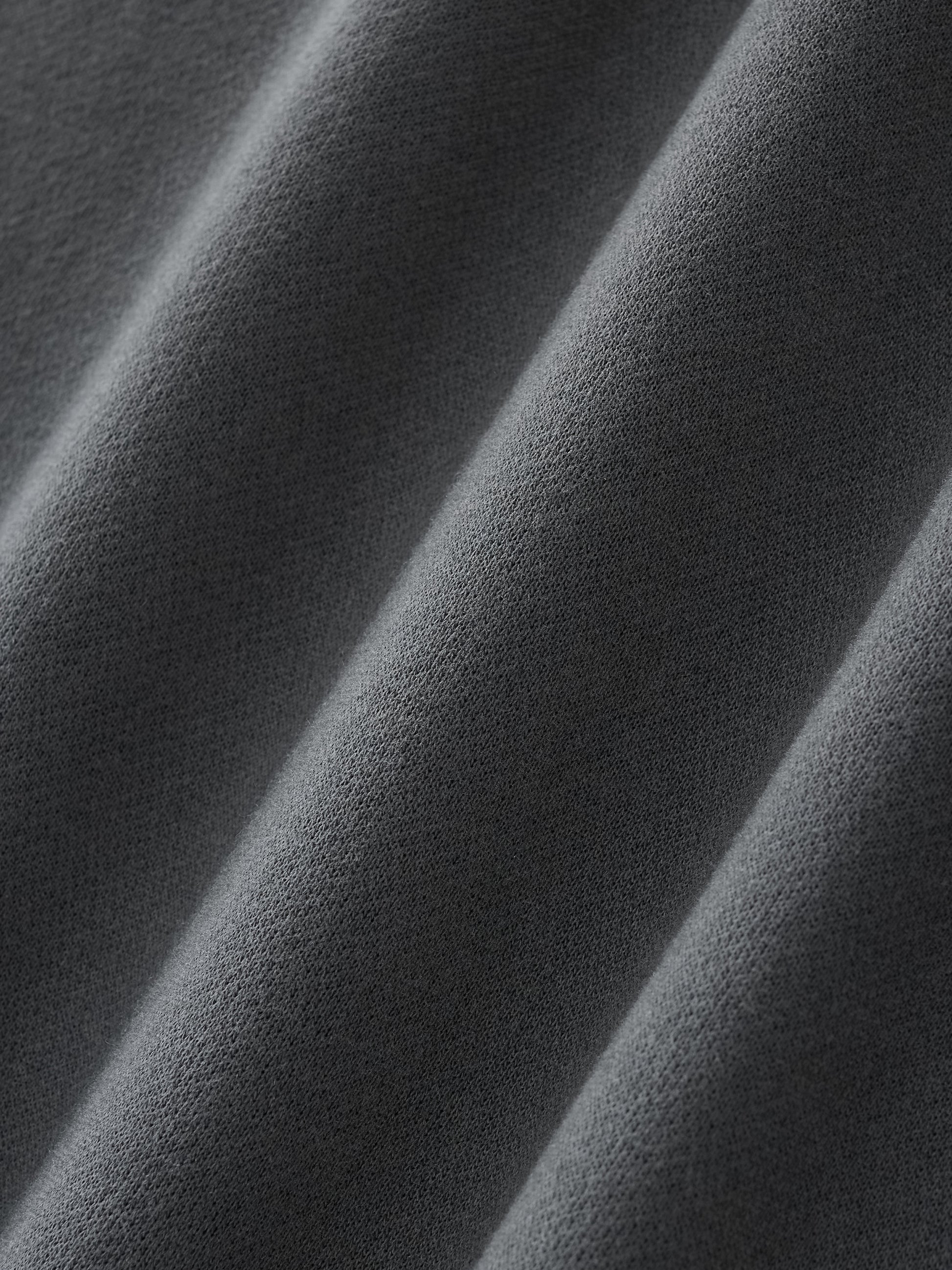 Close up image of a fabric swatch of the Future-Homme three quarter length sweatpant in Black