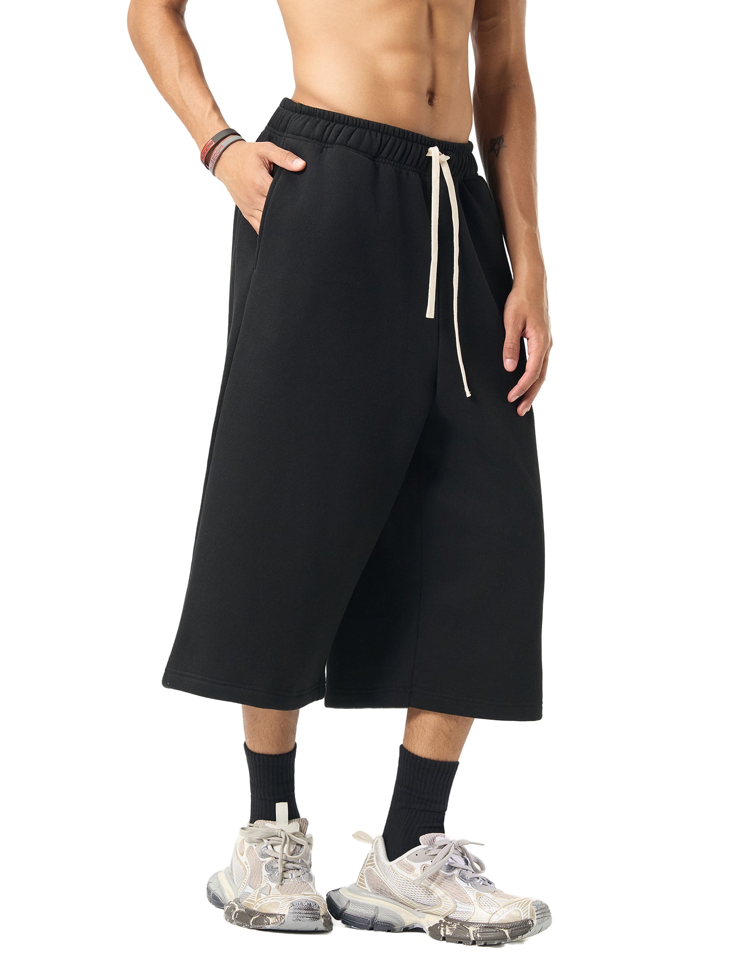 Image of a Future-Homme model wearing a three quarter length sweatpant in 350 GSM in Black, showing the Side view on a White background.
