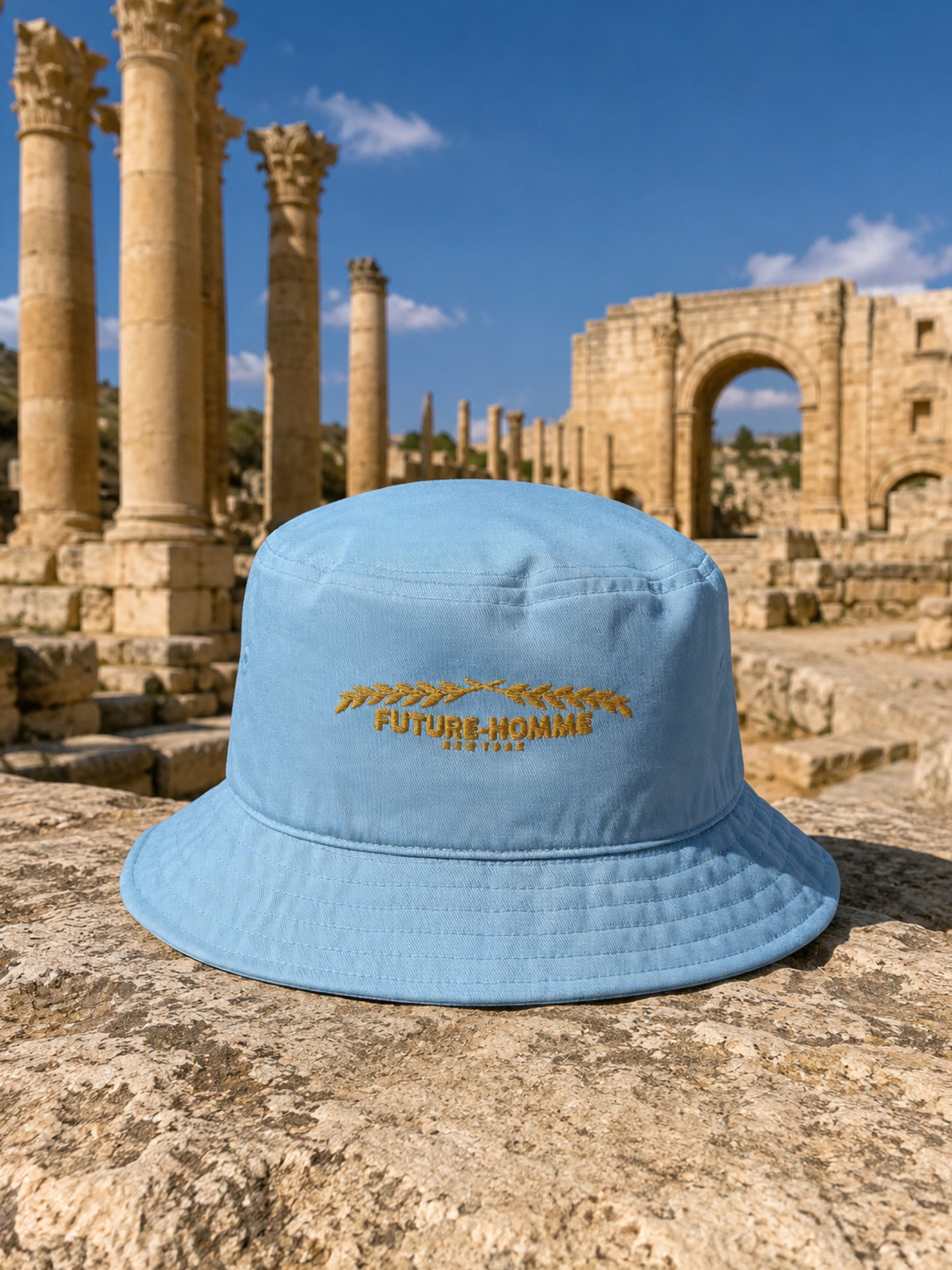 a future-homme bucket hat sitting on a stone in the Jarash ruins. 