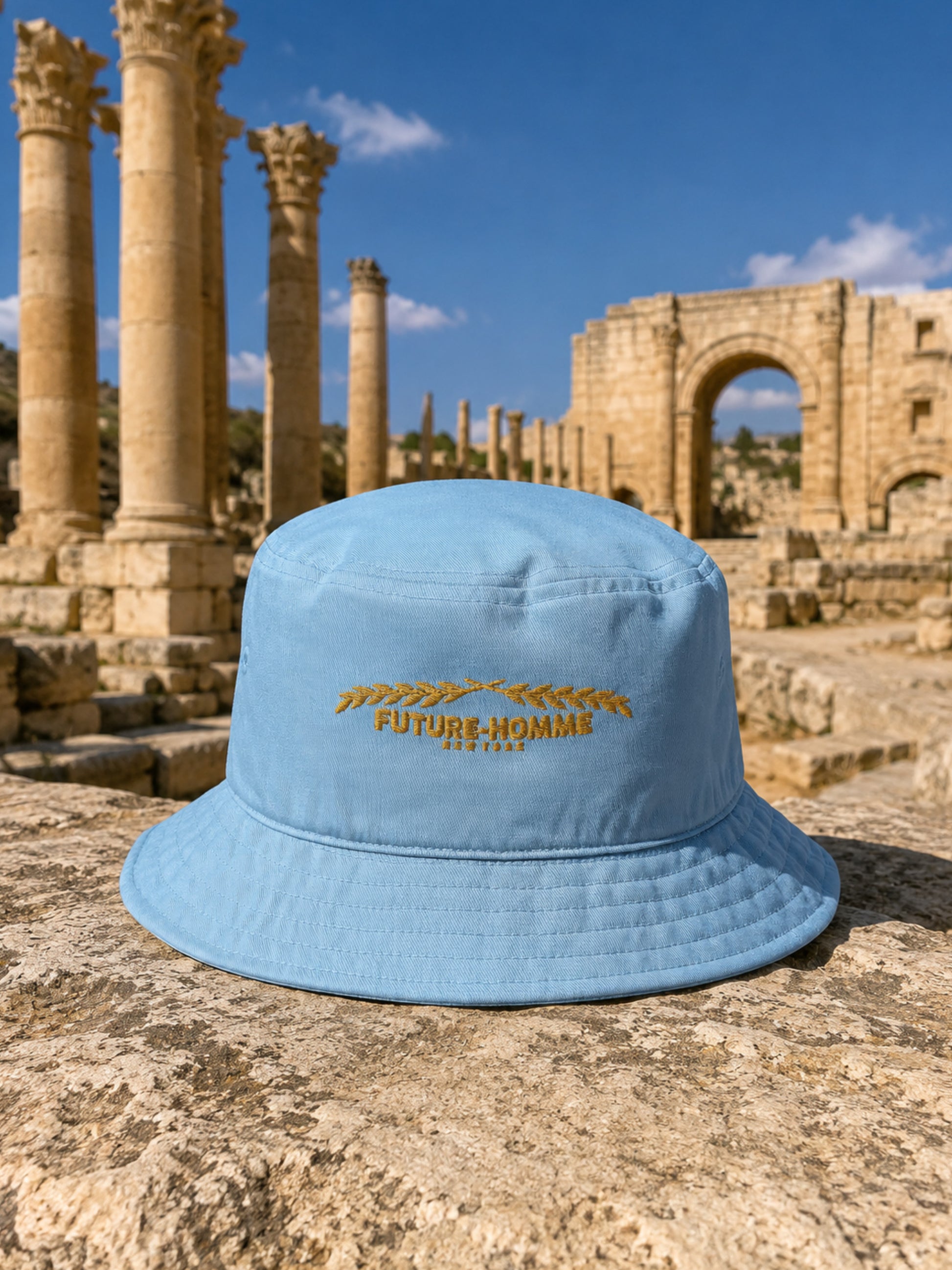 a future-homme bucket hat sitting on a stone in the Jarash ruins. 