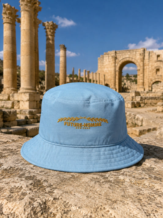 a future-homme bucket hat sitting on a stone in the Jarash ruins. 
