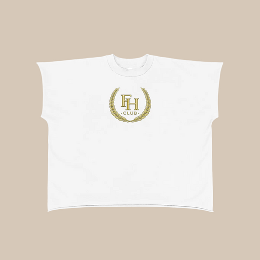 White crop top with gold emblem and text on a white background