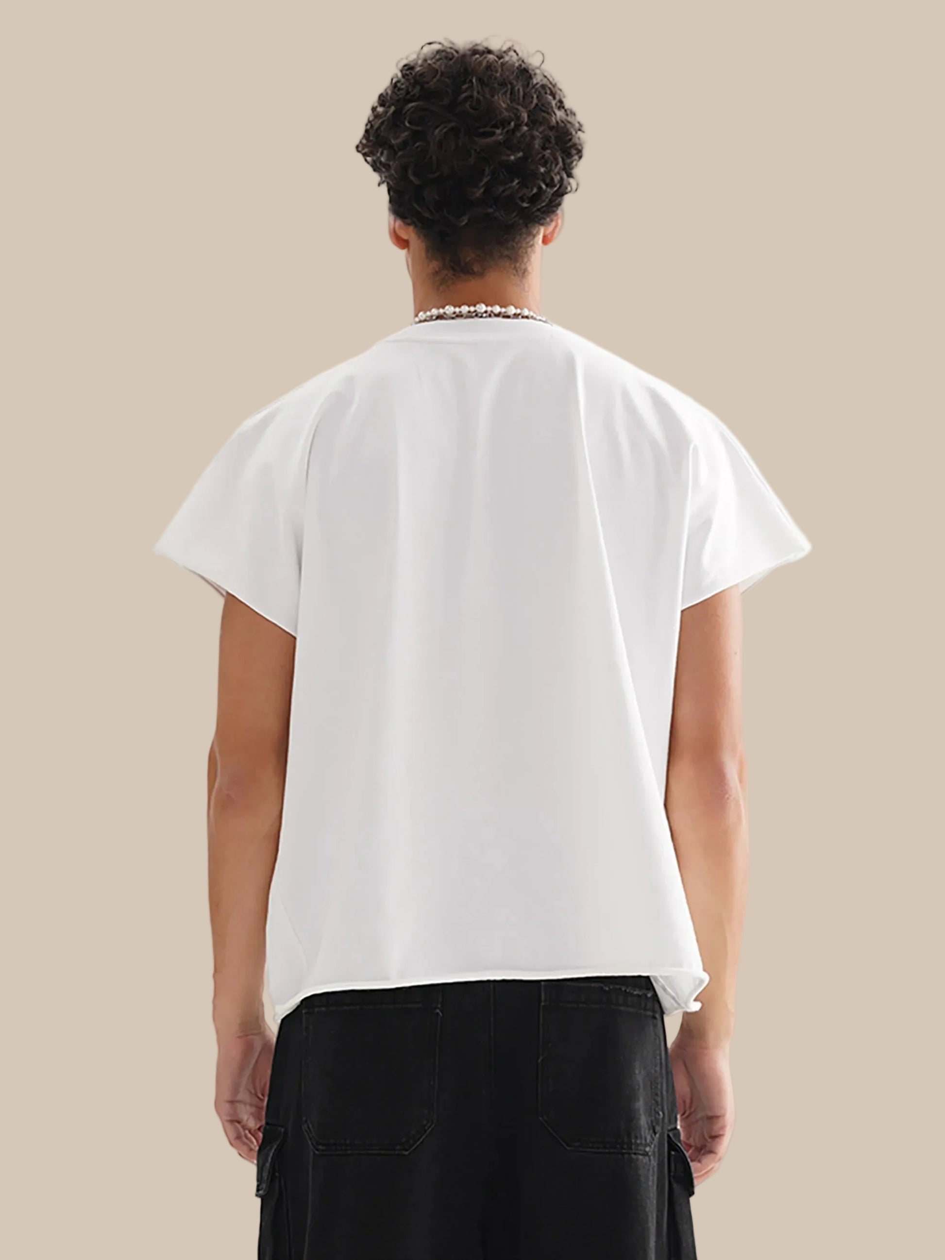Person wearing a white t-shirt and black pants on a white background