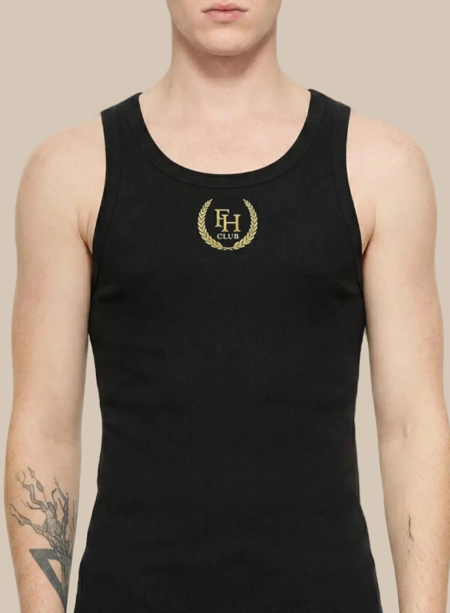 Black tank top with gold logo worn by a person on a white background
