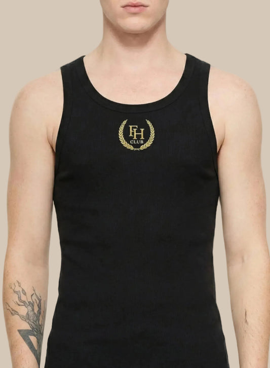 Black tank top with gold logo worn by a person on a white background