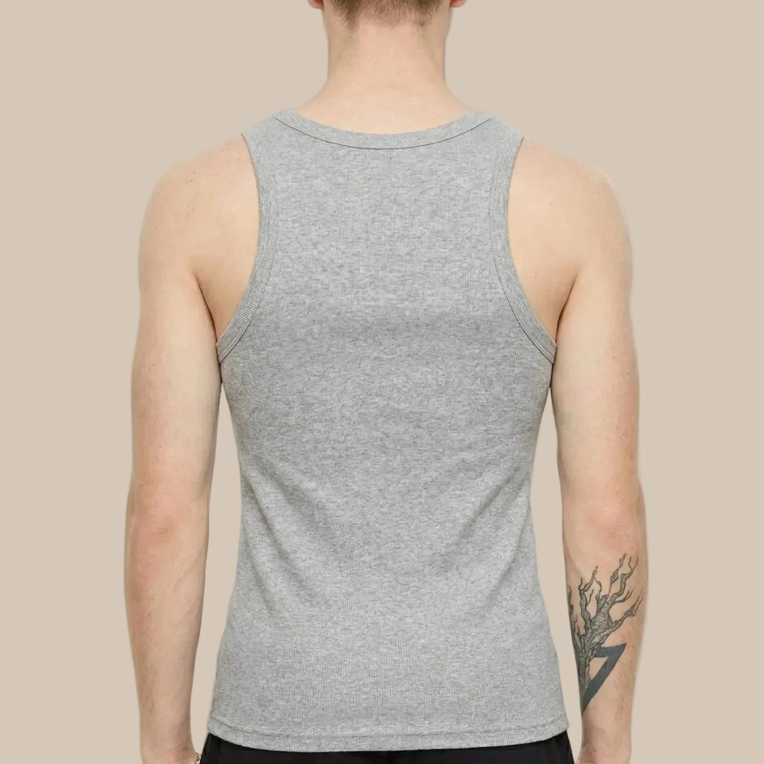 Person wearing a gray tank top on a white background