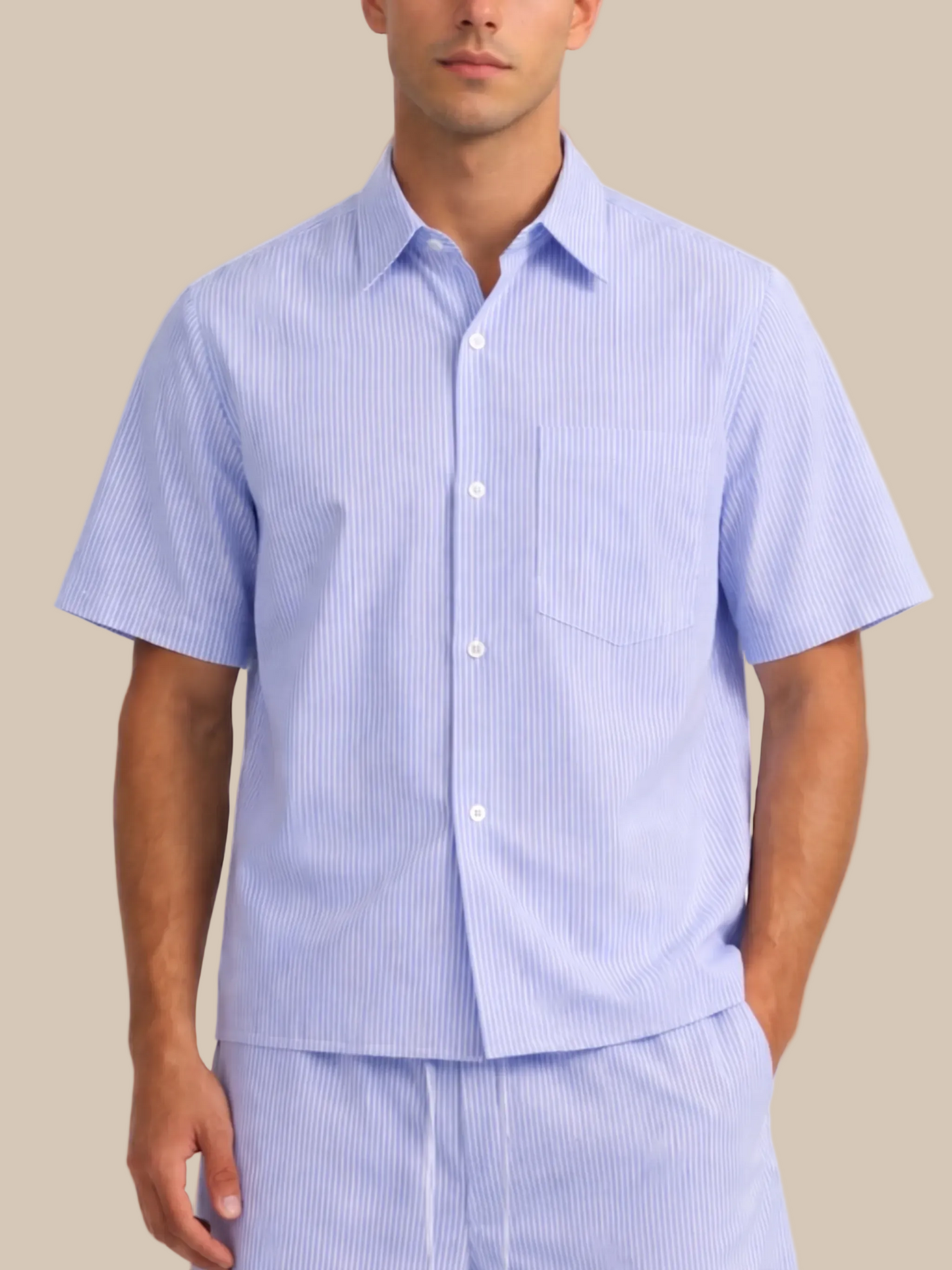 Man wearing a light blue striped shirt and pants on a white background
