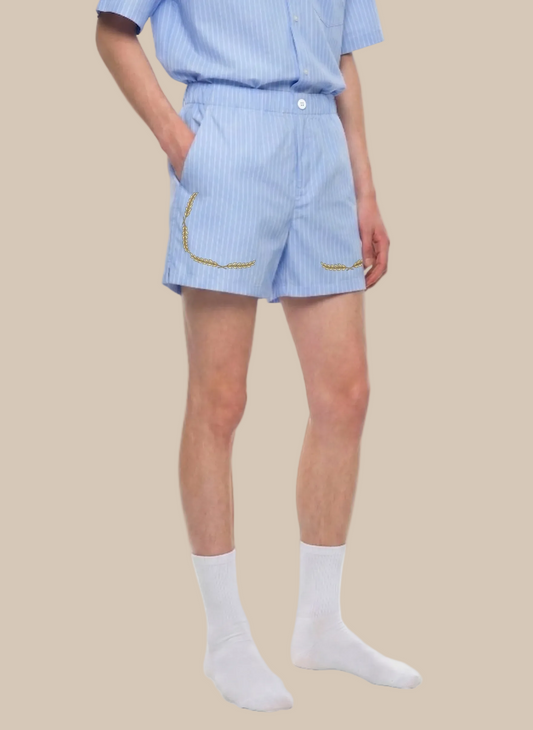 a person wearing light blue pinstripe shorts with a laurel trim on a white background